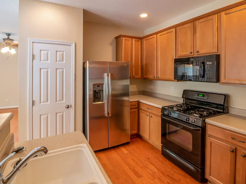 Contemporary kitchen with wooden cabinets and a stainless steel refrigerator Contemporary kitchen with wooden cabinets and a stainless steel refrigerator