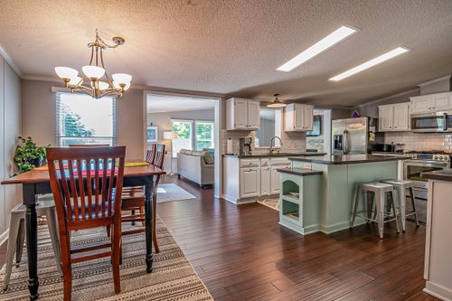 Free Spacious modern kitchen and dining room with elegant interior design elements and natural lighting. Stock Photo