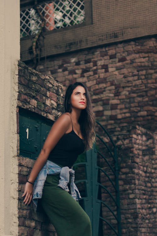 Woman Leaning on a Brick Wall