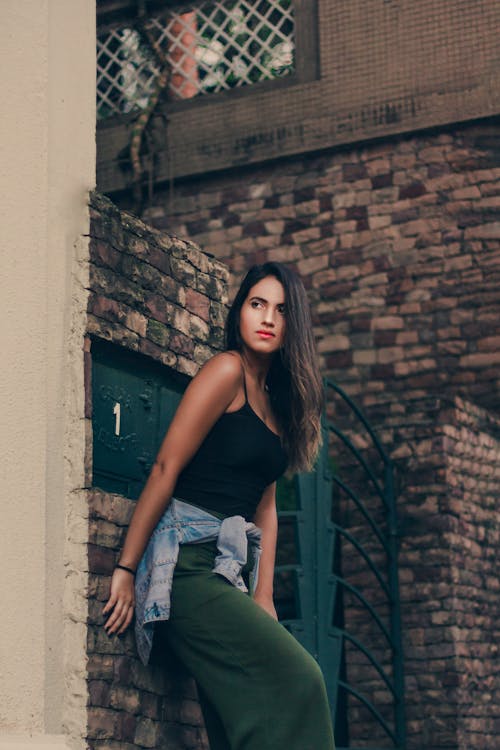 Person Leaning on a Brick Wall