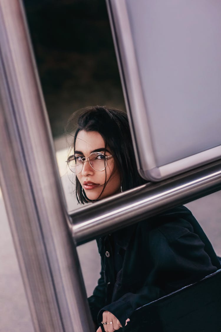 Confident Young Lady Resting In Bus Stop