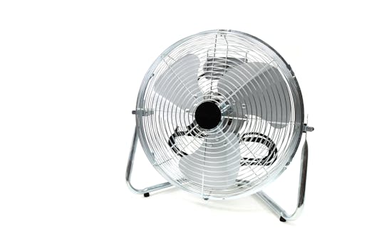 Sleek stainless steel industrial floor fan with metal blades isolated on white.