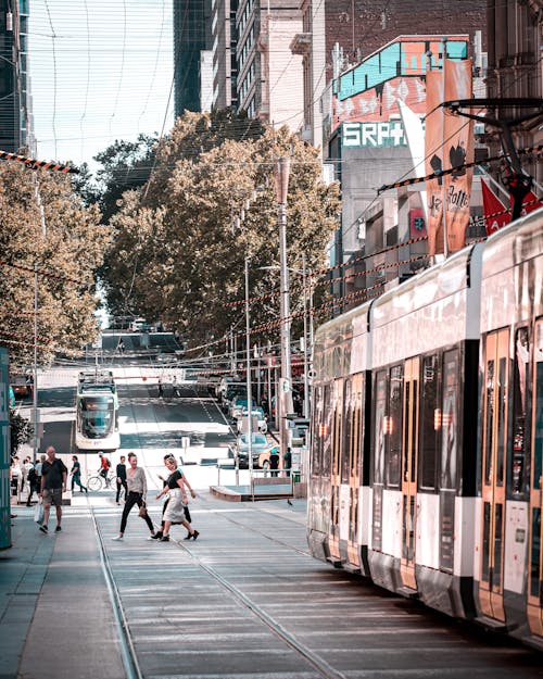 People Walking on the Street Near the Tram