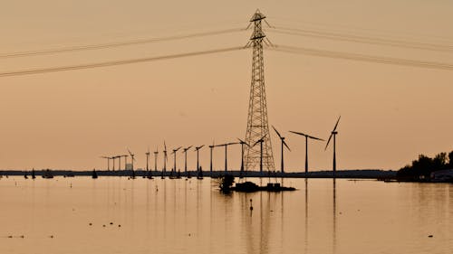 Windmill Near Electric Pylon