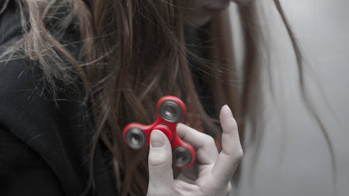 Woman Holding Red Hand Spinner
