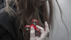 Woman Holding Red Hand Spinner