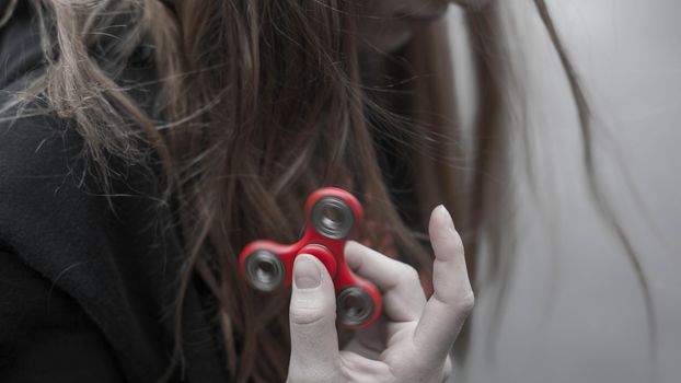Woman Holding Red Hand Spinner