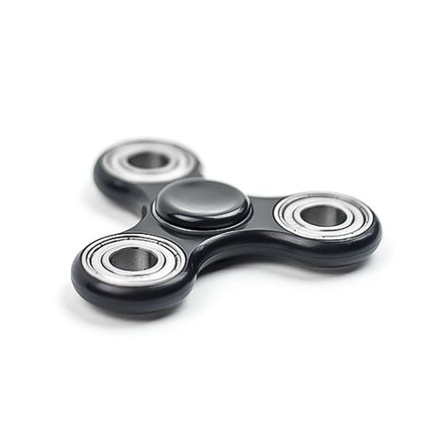 Free A sleek black fidget spinner with metal bearings posed on a clean white background. Stock Photo