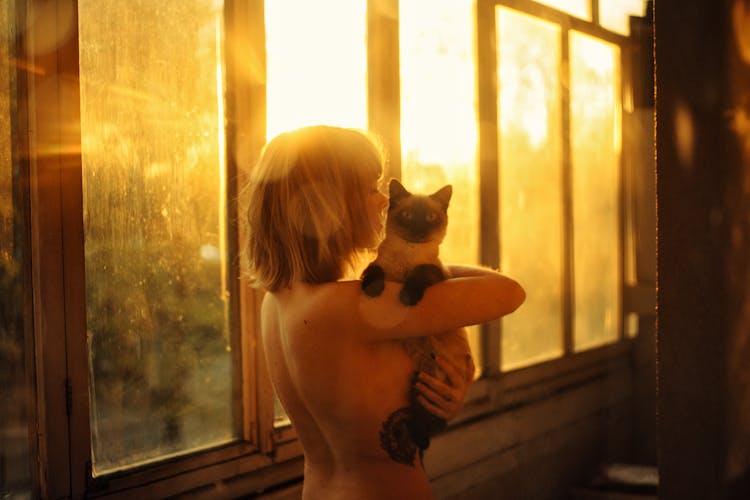 Naked Woman Carrying A Cat