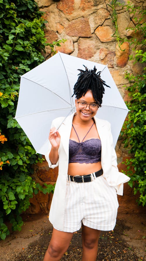 Woman Smiling While Holding an Umbrella