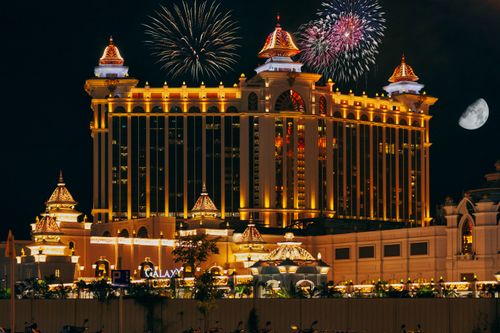 Free Colorful firework over famous modern palace with illuminated facade and square located in Macau at night Stock Photo