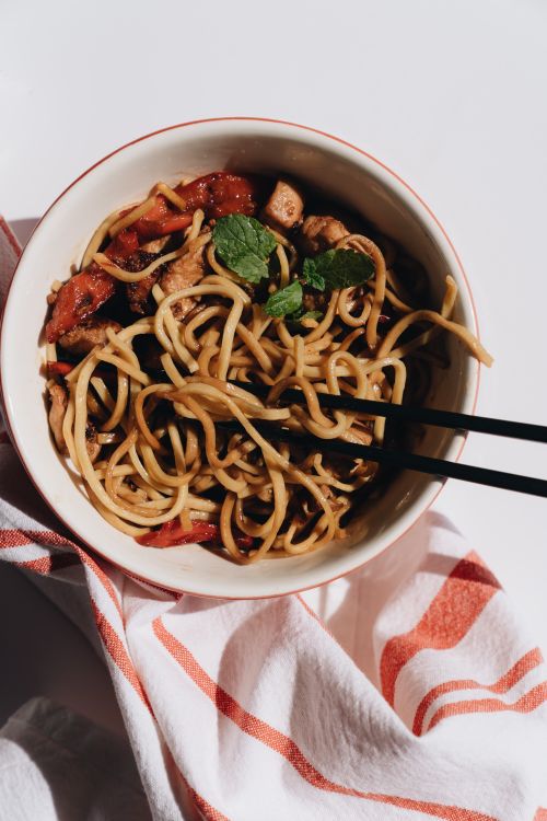Free Top view of a savory noodle bowl with chopsticks, perfect for asian cuisine lovers. Stock Photo