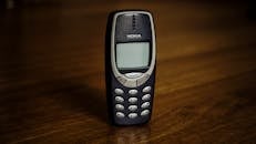 Retro cellphone with buttons placed on table