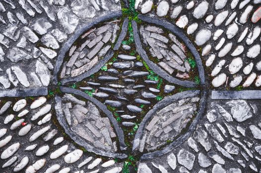 Rough stone pavement with green grass