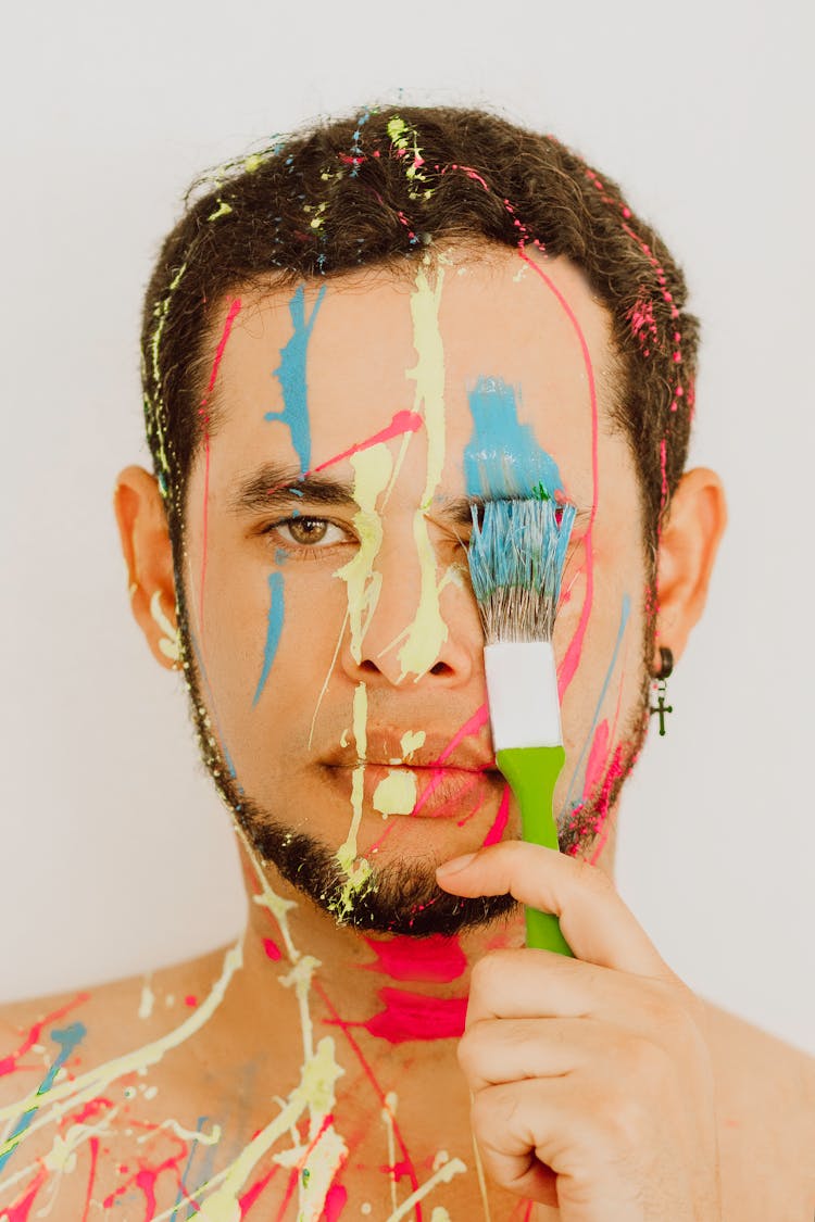 
A Bearded Man Painting His Face