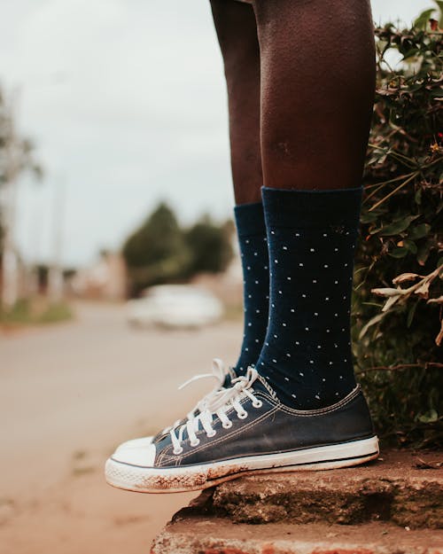 Free Legs of black person in sneakers and socks Stock Photo
