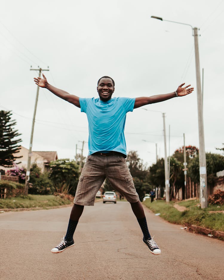 Black Happy Man Jumping On Street