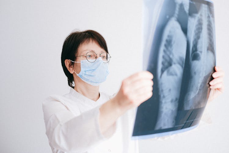 Doctor Looking At Lung Scans She Is Holding