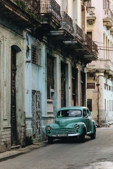A classic Chevrolet car parked on a picturesque street in Cuba, showcasing vintage architecture.