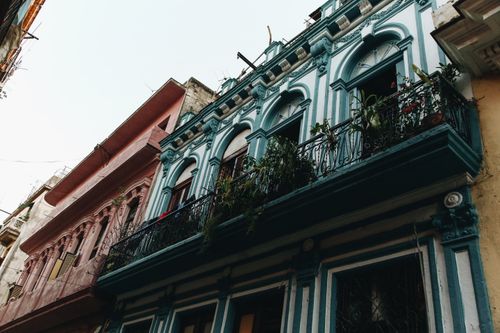 Free Charming city residential buildings with ornate facades and decorative balconies. Stock Photo