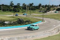 Green Coupe on Gray Asphalt Road