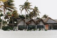 Bungalow among Palm Trees on Sandy Beach