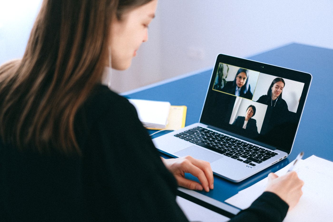 Remote English teacher on a video call interview from a home office setup