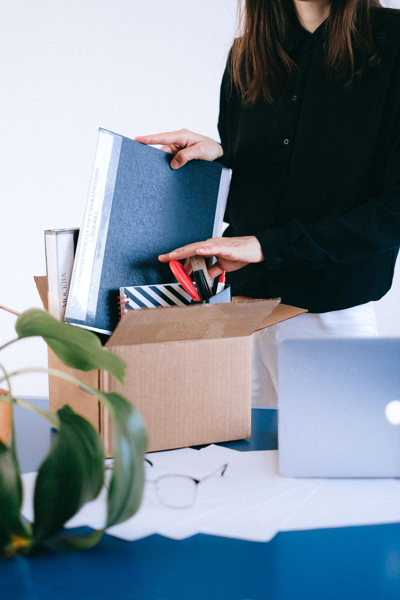 Office documents and supplies being organised into a moving box