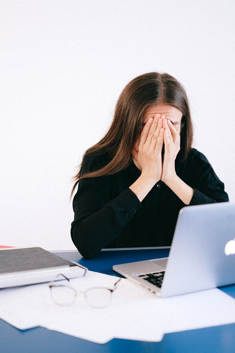 Stressed Woman Covering Her Face With Her Hands