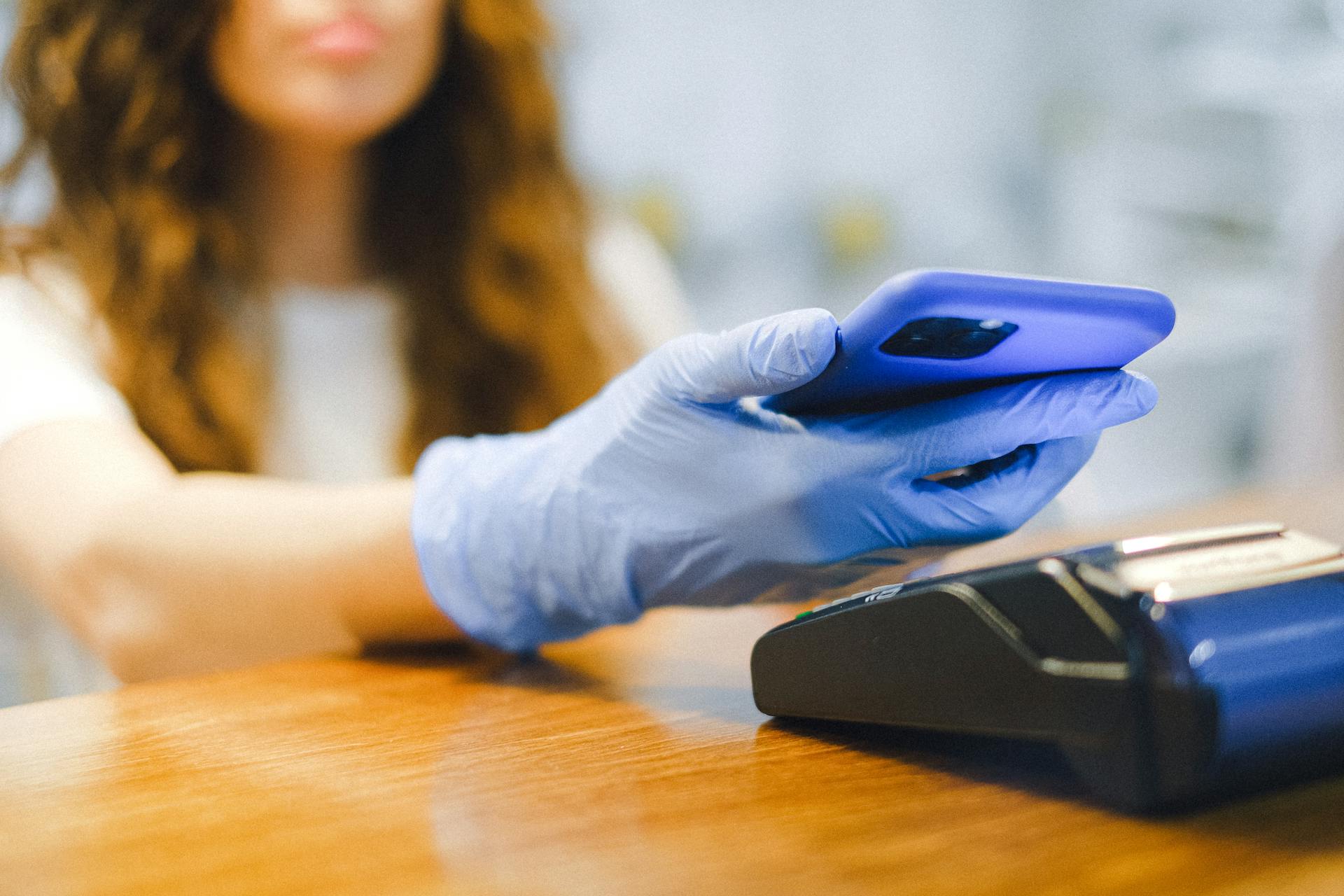 A Woman Paying Using Her Smartphone