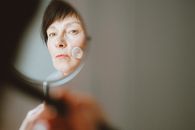 Person Holding Magnifying Glass in Front of the Camera