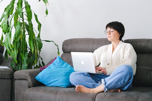 Free Close-Up Shot of a Woman Sitting on Couch  Stock Photo