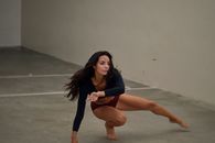 Focused female dancer practicing in room