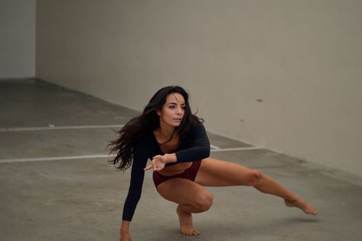Focused female dancer practicing in room