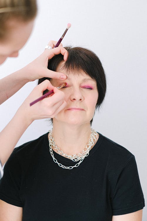 Close-Up Shot of an Elderly Woman Getting an Eye Makeup