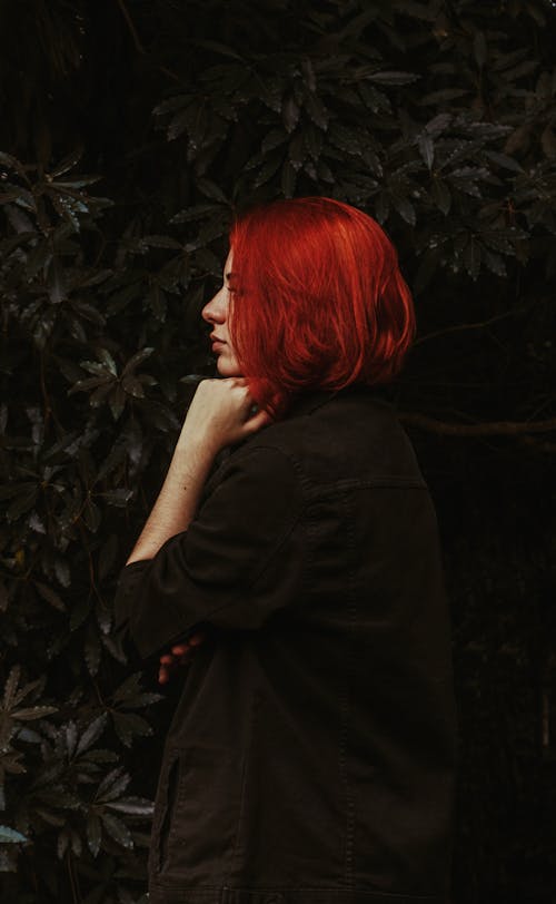 Young serious woman with bright ginger hair