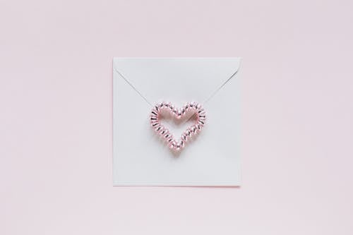 Envelope with handmade bead heart on San Valentines Day