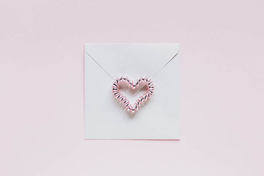 Envelope with handmade bead heart on San Valentines Day