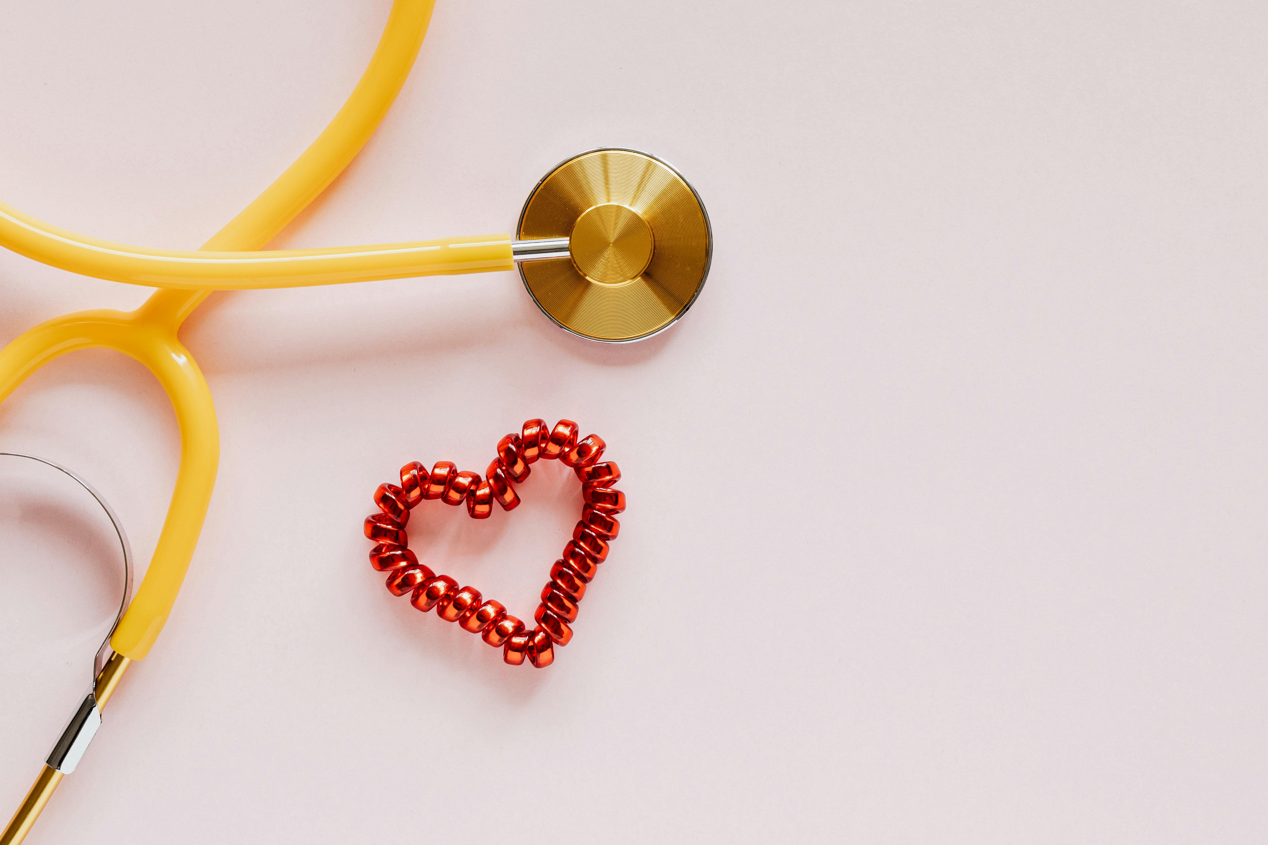 Premium Photo  A heart with a stethoscope on it sits on a wooden table