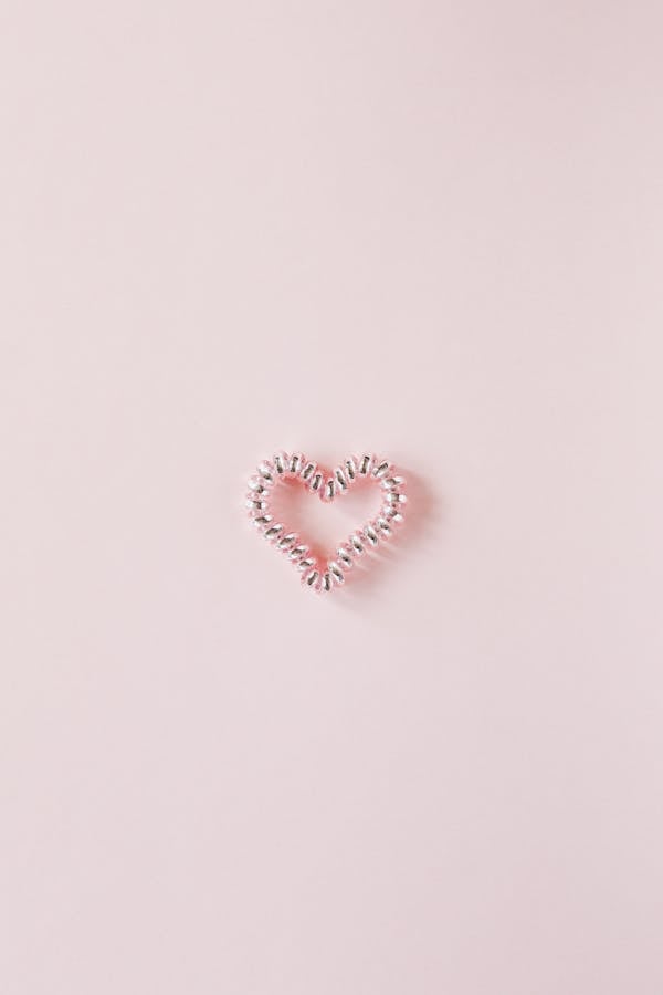 Decorative heart of elastic coil on pink background