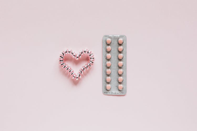 Glistening Heart Near Packaging With Pills