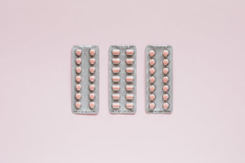 Free Set of various medical pills on pink background Stock Photo