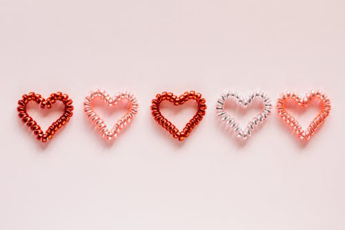 Free Composition of multicolored hearts on pink surface Stock Photo