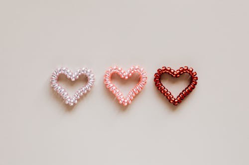 Free Composition of multicolored hearts on beige surface Stock Photo