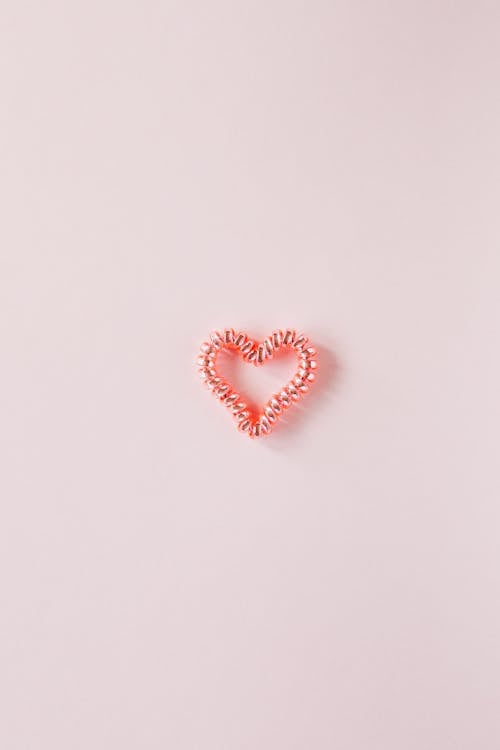 Free Small decorative heart on smooth pink surface Stock Photo