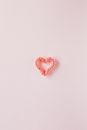 Small decorative heart on smooth pink surface