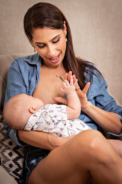Free Mother Breastfeeding her Baby  Stock Photo