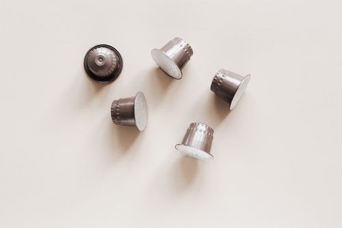 Free From above of pods for preparing espresso in coffee machine for breakfast and awakening in morning placed on white table Stock Photo