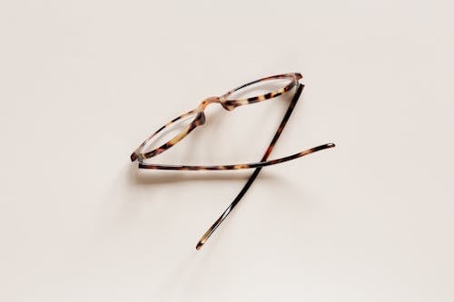 Free Stylish eyeglasses placed on beige surface Stock Photo