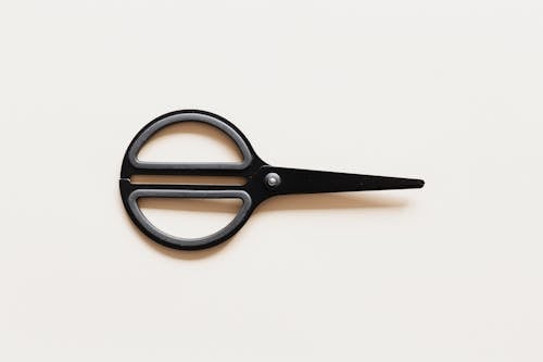 Small scissors placed on beige background